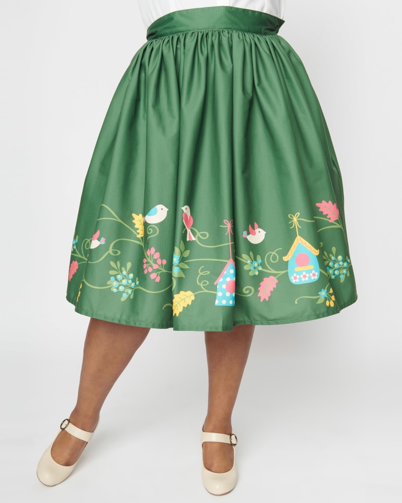 Front of a model wearing a size 1X Unique Vintage Green Bird House Gellar Swing Skirt in Green by Unique Vintage. | dia_product_style_image_id:302435